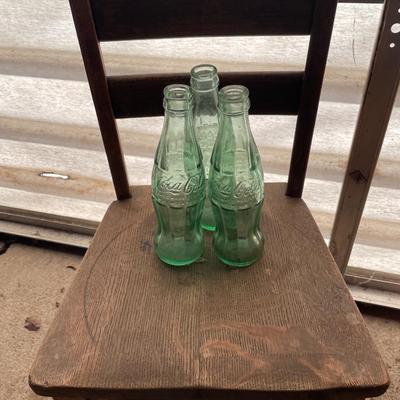 Small vintage kids chair with 3 coke bottles