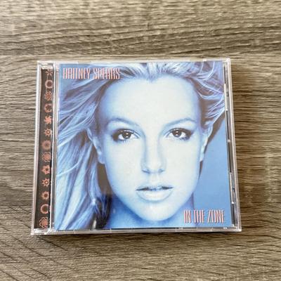 LOT 105A: Y2K Britney Spears Planet Hollywood Ladies' Shirt (Large) & Collection of CDs: Britney Spears' Boys, Don't...