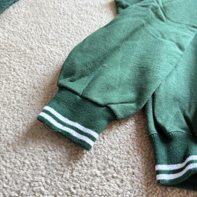 LOT 216A: NFL Team Merch: Green Bay Packers (Shirts, Jersey, Sweatpants), Miami Dolphins (Bedazzled Tee, Dan Marino Starter T, Jersey),...