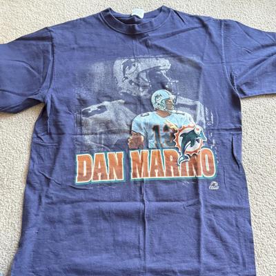 LOT 216A: NFL Team Merch: Green Bay Packers (Shirts, Jersey, Sweatpants), Miami Dolphins (Bedazzled Tee, Dan Marino Starter T, Jersey),...