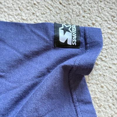 LOT 216A: NFL Team Merch: Green Bay Packers (Shirts, Jersey, Sweatpants), Miami Dolphins (Bedazzled Tee, Dan Marino Starter T, Jersey),...