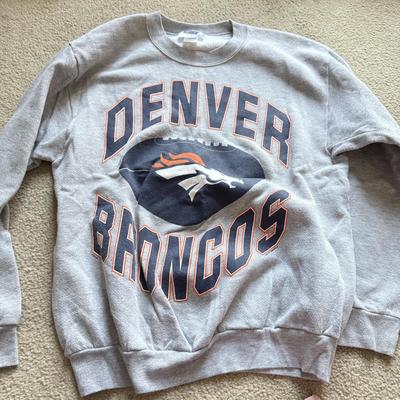 LOT 216A: NFL Team Merch: Green Bay Packers (Shirts, Jersey, Sweatpants), Miami Dolphins (Bedazzled Tee, Dan Marino Starter T, Jersey),...