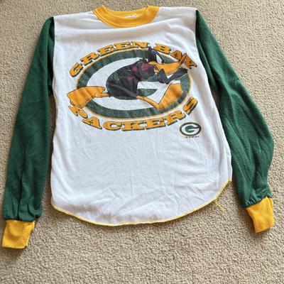 LOT 216A: NFL Team Merch: Green Bay Packers (Shirts, Jersey, Sweatpants), Miami Dolphins (Bedazzled Tee, Dan Marino Starter T, Jersey),...