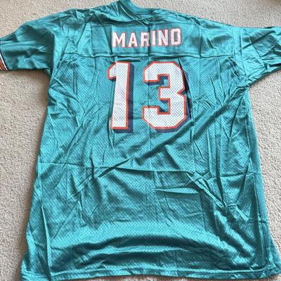 LOT 216A: NFL Team Merch: Green Bay Packers (Shirts, Jersey, Sweatpants), Miami Dolphins (Bedazzled Tee, Dan Marino Starter T, Jersey),...
