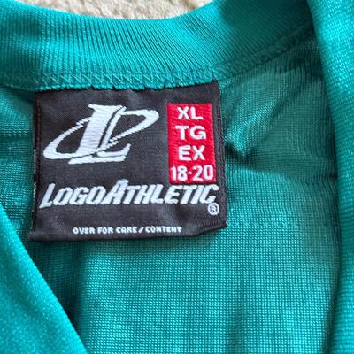 LOT 216A: NFL Team Merch: Green Bay Packers (Shirts, Jersey, Sweatpants), Miami Dolphins (Bedazzled Tee, Dan Marino Starter T, Jersey),...