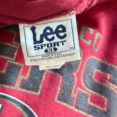 LOT 216A: NFL Team Merch: Green Bay Packers (Shirts, Jersey, Sweatpants), Miami Dolphins (Bedazzled Tee, Dan Marino Starter T, Jersey),...