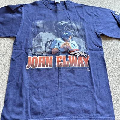 LOT 216A: NFL Team Merch: Green Bay Packers (Shirts, Jersey, Sweatpants), Miami Dolphins (Bedazzled Tee, Dan Marino Starter T, Jersey),...