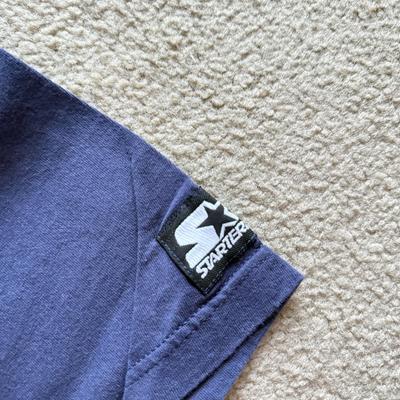 LOT 216A: NFL Team Merch: Green Bay Packers (Shirts, Jersey, Sweatpants), Miami Dolphins (Bedazzled Tee, Dan Marino Starter T, Jersey),...