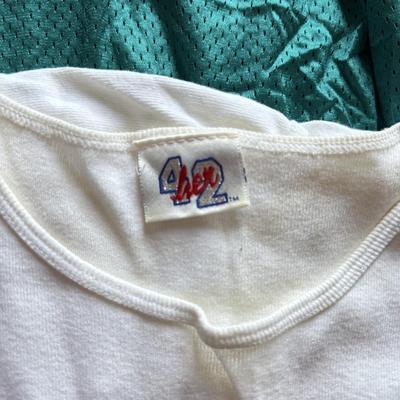 LOT 216A: NFL Team Merch: Green Bay Packers (Shirts, Jersey, Sweatpants), Miami Dolphins (Bedazzled Tee, Dan Marino Starter T, Jersey),...