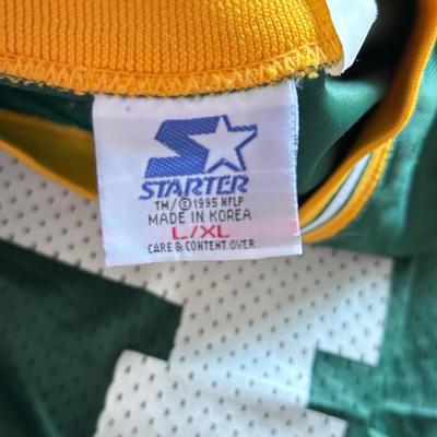 LOT 216A: NFL Team Merch: Green Bay Packers (Shirts, Jersey, Sweatpants), Miami Dolphins (Bedazzled Tee, Dan Marino Starter T, Jersey),...