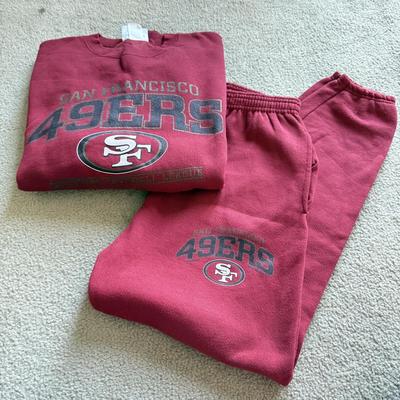 LOT 216A: NFL Team Merch: Green Bay Packers (Shirts, Jersey, Sweatpants), Miami Dolphins (Bedazzled Tee, Dan Marino Starter T, Jersey),...