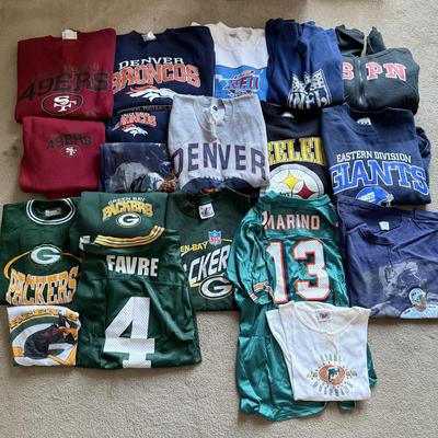 LOT 216A: NFL Team Merch: Green Bay Packers (Shirts, Jersey, Sweatpants), Miami Dolphins (Bedazzled Tee, Dan Marino Starter T, Jersey),...
