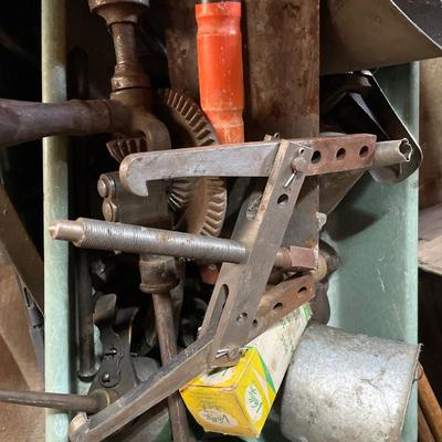 Green tin of vintage metal items