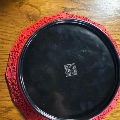 Red plate with scene in relief