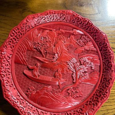 Red plate with scene in relief