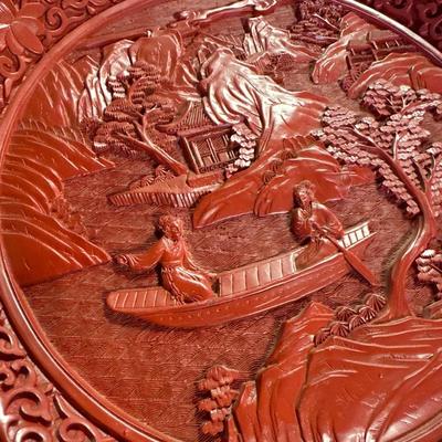 Red plate with scene in relief