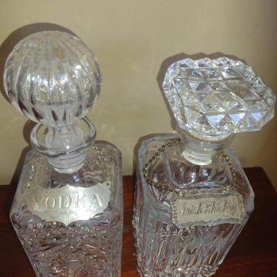 Pair of Glass/Crystal Decanters with Metal Tag Labels