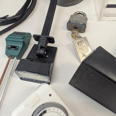 Assortment Of Yard Tools Sofa Legs Timers