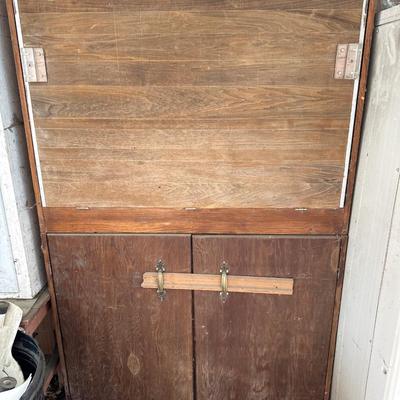2 brown wood cabinets stacked on top of each other