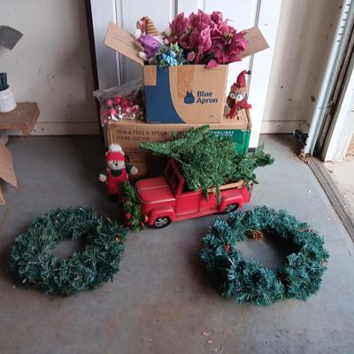 PRE-LIT TREE ON TOP OF RED TRUCK, WREATHS, FAUX FLOWERS AND SMALL PLUSH ANIMALS