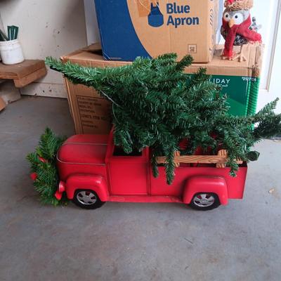 PRE-LIT TREE ON TOP OF RED TRUCK, WREATHS, FAUX FLOWERS AND SMALL PLUSH ANIMALS