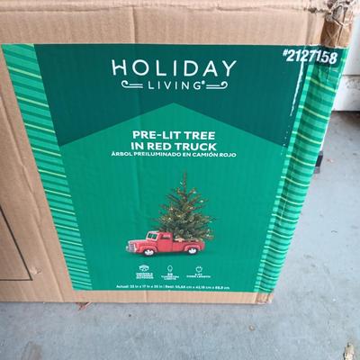 PRE-LIT TREE ON TOP OF RED TRUCK, WREATHS, FAUX FLOWERS AND SMALL PLUSH ANIMALS
