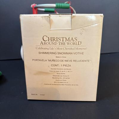 LOT 289: Hand-Crafted Counted Cross-Stiches, Home Decor Peppermint Tri Cycle, Christmas Around the World Shimmering Snowman Votive &...