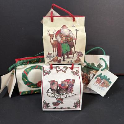 LOT 290: Holiday Candle Collection & More: Santa & Snowman Tapered Candles,Gift Bag Music Boxes, Gold Bead Garland, Peppermint...