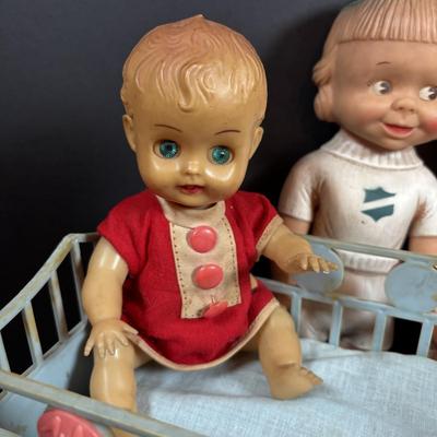 LOT 406: Vintage Doll Collection: Irwin Kewpie Doll, Plastic Doll w/Sleepy Eyes, Blue Doll Crib, Rubber Salvation Army Doll, Squeaky...
