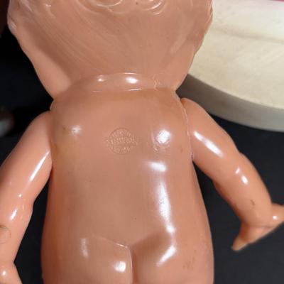 LOT 406: Vintage Doll Collection: Irwin Kewpie Doll, Plastic Doll w/Sleepy Eyes, Blue Doll Crib, Rubber Salvation Army Doll, Squeaky...