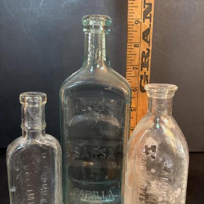 LOT 412: Vintage/Antique Bottles: McCormick, Hoods Sarsaparilla, Hires Household & More