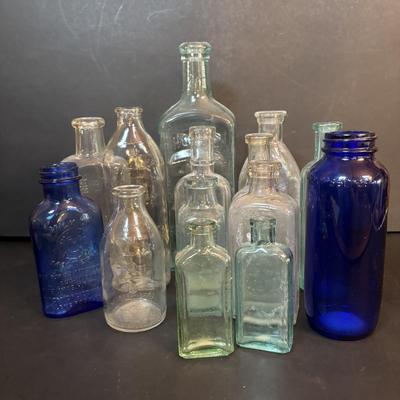 LOT 412: Vintage/Antique Bottles: McCormick, Hoods Sarsaparilla, Hires Household & More