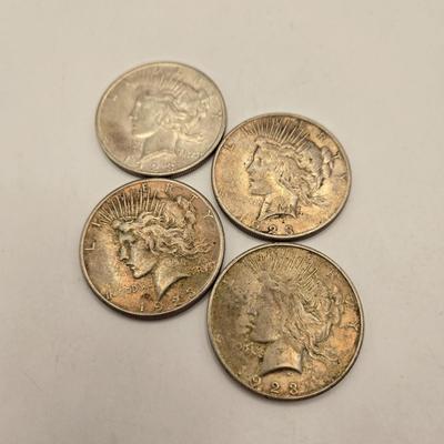 LOT 101J: 4 1923 Peace Silver Dollars