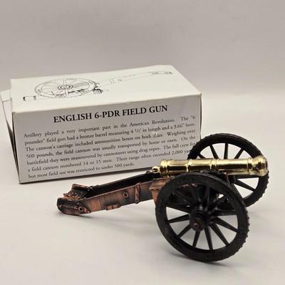 LOT 114K: Two Piggy Banks, Avon Cologne Decanters, & Small Replica of English Field Gun