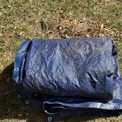 LARGE BLUE TARP AND SOME YARD DECOR