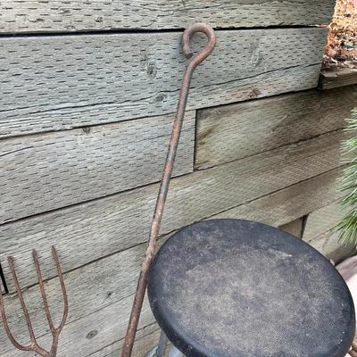 IRON WEDGES, RUSTIC LOOKING FORKS, A HORSE SHOE AND A BAR STOOL