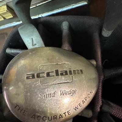 Golf clubs, bag and umbrella