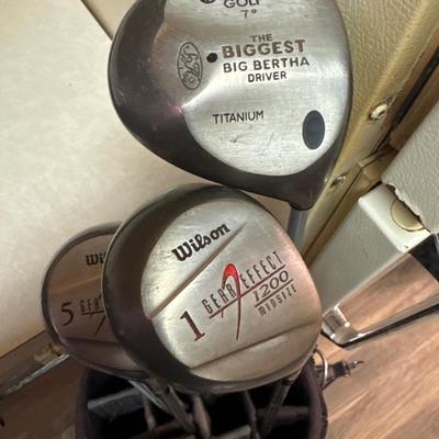 Golf clubs, bag and umbrella