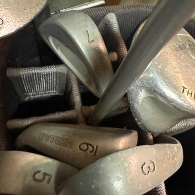 Golf clubs, bag and umbrella