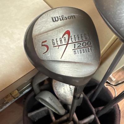 Golf clubs, bag and umbrella