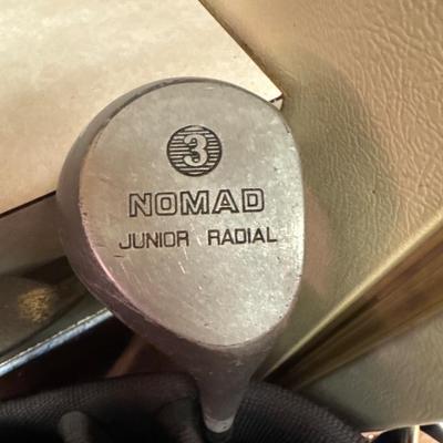 Golf clubs, bag and umbrella