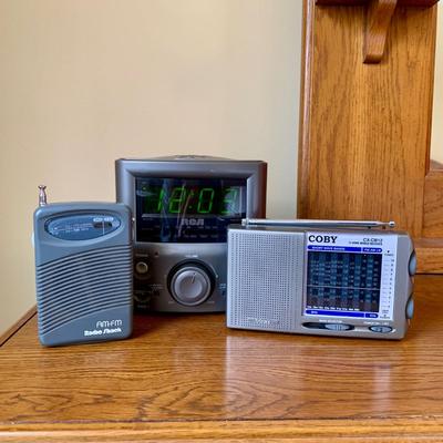 LOT 249 Z: RCA CD Player Clock Radio Model #RP3751A, Coby 12 Band World Receiver Model #CX-CB12, & Radio Shack Handheld AM/FM Radio