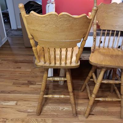 2 SWIVEL OAK BAR STOOLS