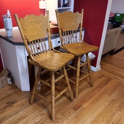 2 SWIVEL OAK BAR STOOLS