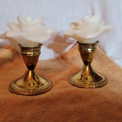 Two Brass candle holders with rose wax candles