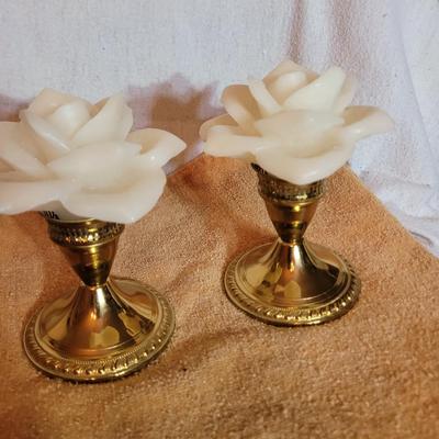 Two Brass candle holders with rose wax candles