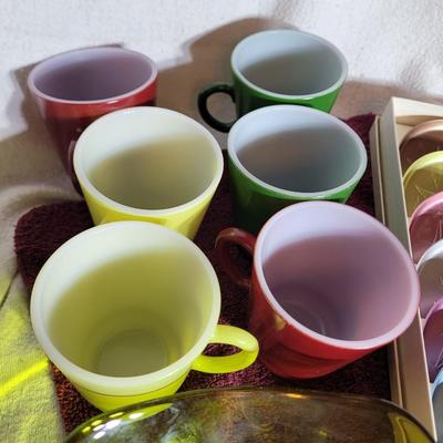 Coasters, colorful coffee cups and green crystal candy dish