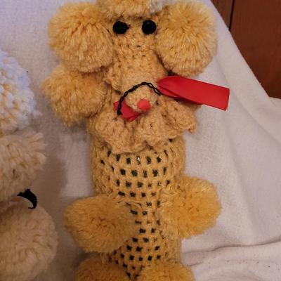 Knitted poodles around a wine bottle