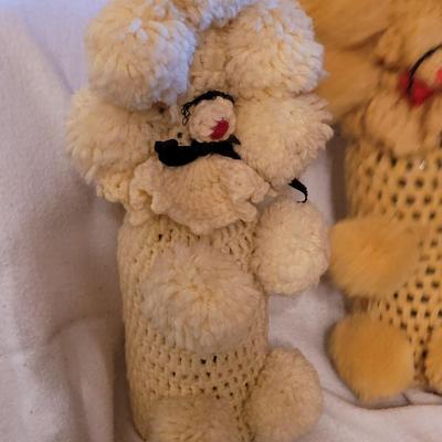 Knitted poodles around a wine bottle