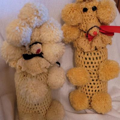 Knitted poodles around a wine bottle